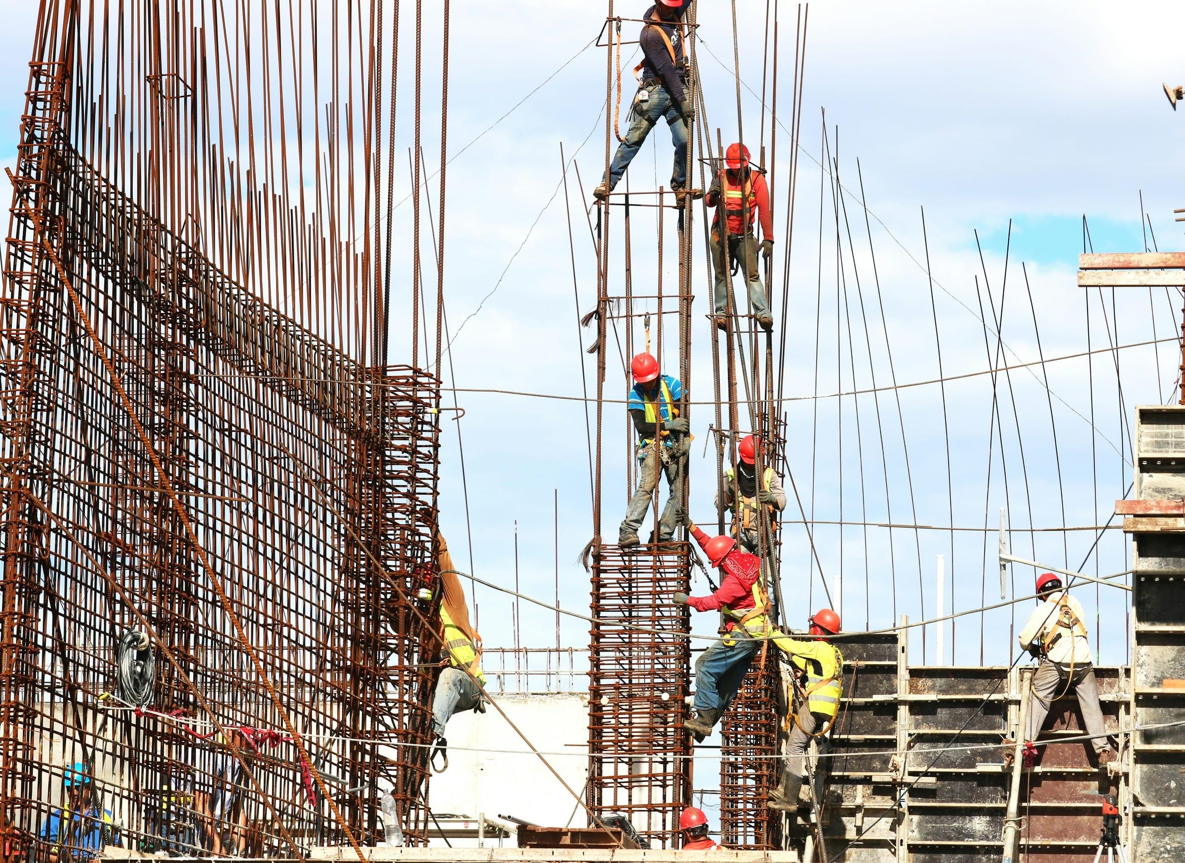 A crew working on reinforcing steel at height on a building site.